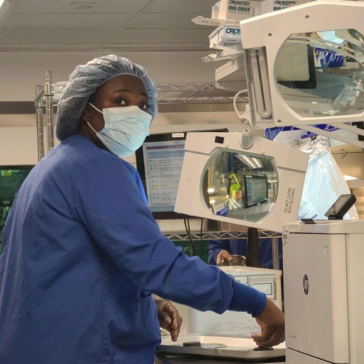 ATS sterile processing graduate in scrubs and PPE