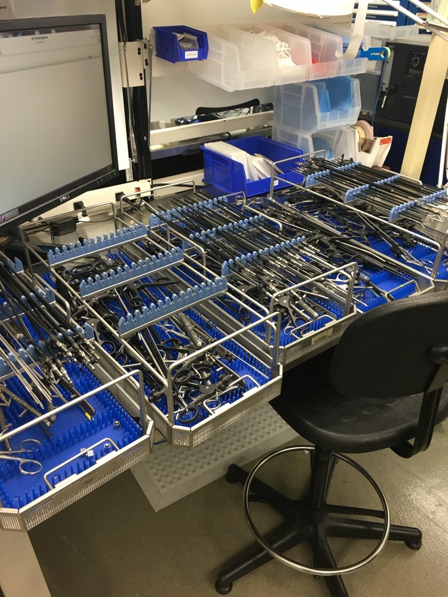 Sterile processing workstation lined with real instrument trays